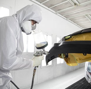 Collision Center Technician Painting a Vehicle | Koch Route 2 Toyota in Lancaster MA